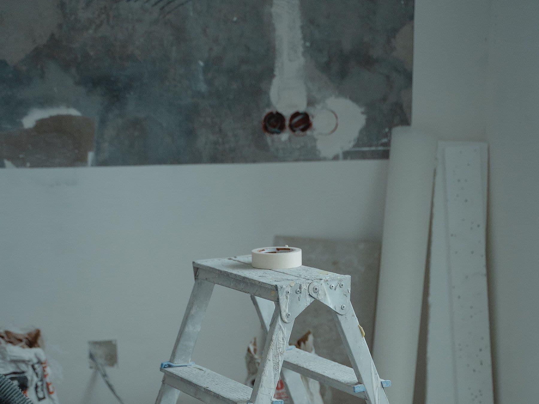 Bathroom mid-remodel with fresh drywall, a step ladder and rough-in plumbing